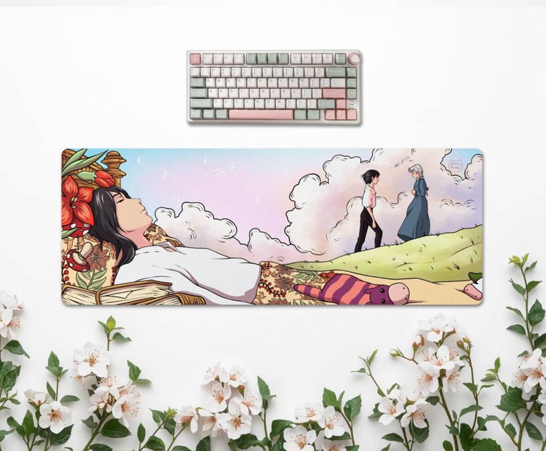May include: A rectangular desk mat featuring an anime-style illustration of a person lying down, with a keyboard above. The mat has a pastel sky background and a scene of two figures walking on a hill. The keyboard has white, pink, and green keys.