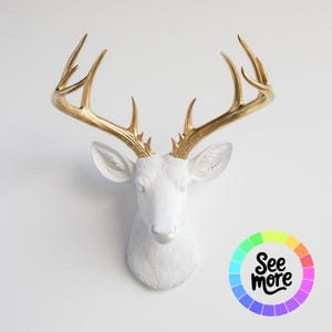 May include: A white deer head wall mount with gold-colored antlers. The deer head is a decorative item, likely for home decor. The image includes a colorful graphic with the text "See more".
