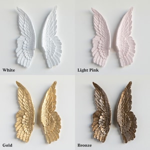 four different colored angel wings, each with a unique color and design.