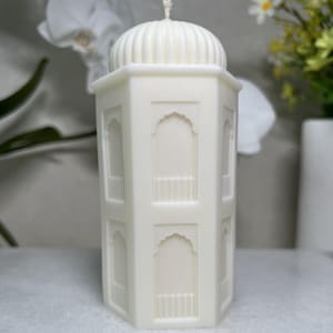 Seitliche Ansicht einer hohen islamischenMoschee Kerze mit klaren Linien minimalistischer Form Rapswachs istungefärbt.Geeignet als moderne Ramadan Dekoration,islamische Deko hochwertiges Geschenk zu Eid Mubarak.Nahaufnahme einer islamischen Moschee Kerze mit feinen FensterdetailsKuppel.Diese handgegossene Ramadan Kerze ist duftfrei,bewusst schlicht gehalten.Ideal als ruhige Tischdeko,dekoratives Element für das Zuhause,als stilvolles islamisches Geschenk.eignet sich besonders ,Wohnräume
