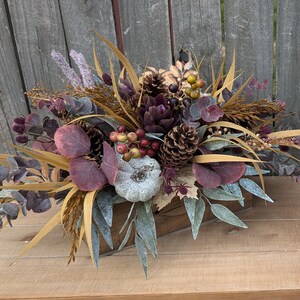 Box arrangements in burgundy and purple with pumpkins