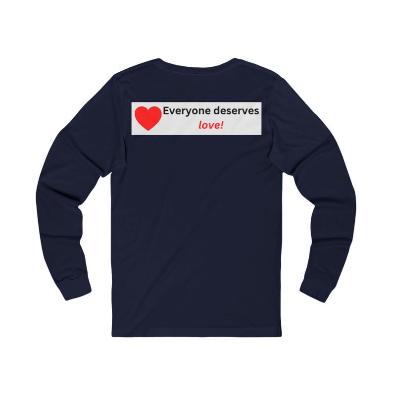 Back view of a navy blue long-sleeve t-shirt showing a white rectangular graphic near the collar with a red heart and the text Everyone deserves love!.