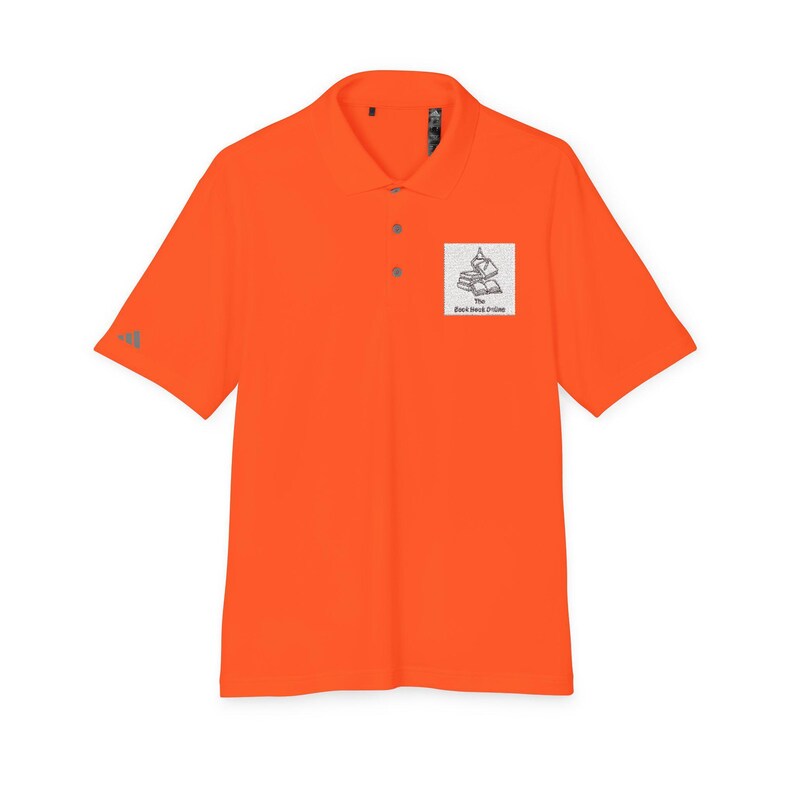 A short-sleeved bright orange polo shirt with a collar, three buttons, and a white square graphic of stacked books with text on the left chest.