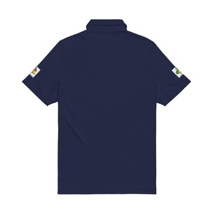 The back of a navy blue polo shirt displaying a plain solid back and embroidered patches on the sleeves against a white background.