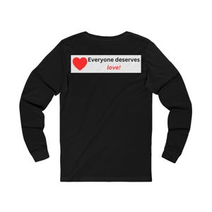Back view of a black long-sleeve t-shirt featuring a rectangular upper back graphic with a red heart and the text Everyone deserves love!.
