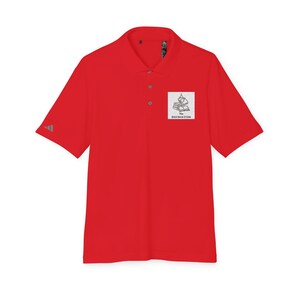 A short-sleeved red polo shirt with a collar, three buttons, and a white square graphic of stacked books with text on the left chest.