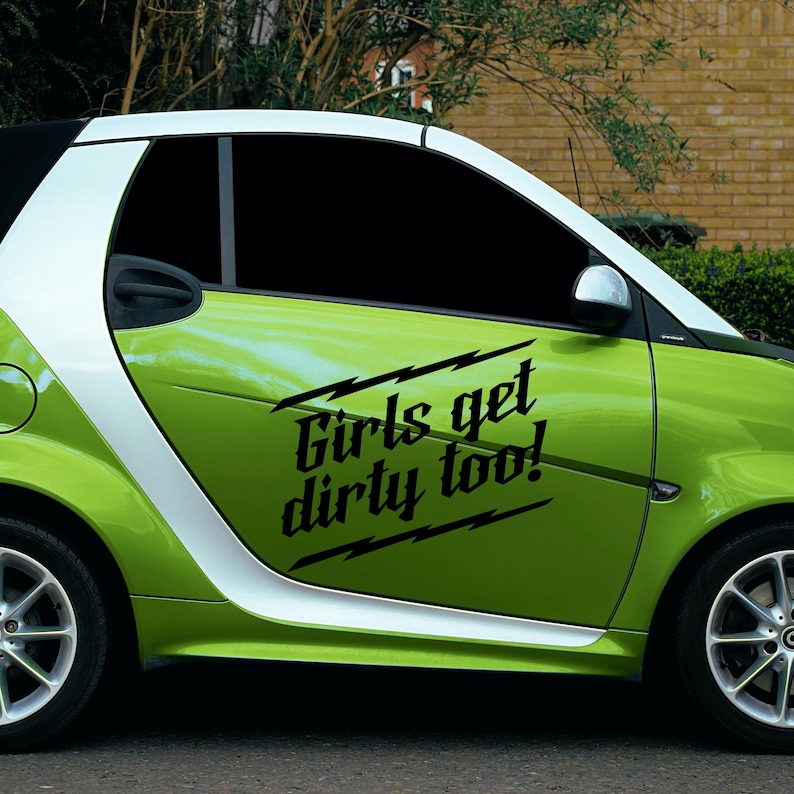 May include: A green and white Smart car with the text "Girls get dirty too!" in black. The car has a white stripe along the side and a black roof. The wheels are silver.