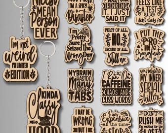 May include: A collection of light-colored wooden keychains featuring dark engraved text with humorous phrases such as Nicest Mean Person Ever, I'm Not A Hot Mess, My Brain Has Too Many Open Tabs, and I Put The Pro In Procrastinate, each with a metal ring.