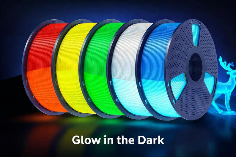 May include: Spools of glow-in-the-dark 3D printing filament in red, orange, yellow, green, white, and blue. The image includes a glowing blue deer silhouette and the text "Glow in the Dark".
