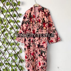 May include: A pink floral print robe with a bird and floral design. The robe is hanging on a hanger. The text "PINKCITY TEXTILE" is visible at the bottom of the image.