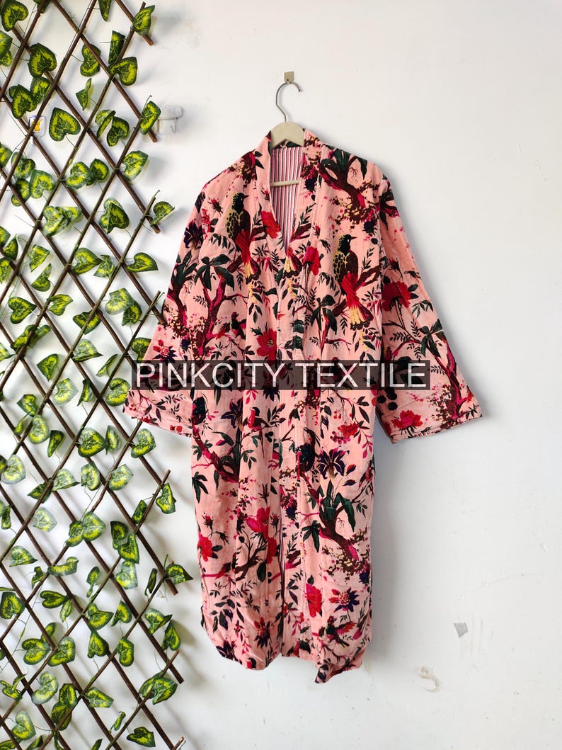 May include: A pink floral print robe with a bird and floral design. The robe is hanging on a hanger. The text "PINKCITY TEXTILE" is visible at the bottom of the image.