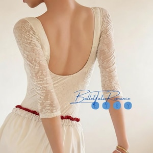 May include: Cream-colored leotard with floral lace sleeves and a low back. The leotard is paired with a white skirt and a red waistband. The Etsy shop name "BalletTutuRomance" is written in cursive.