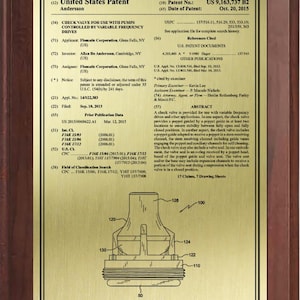 May include: A framed patent document with a gold-colored plate and a dark brown wooden frame. The plate features text and a technical drawing of a check valve, including labels and measurements. The patent number is US 9,163,737 B2.