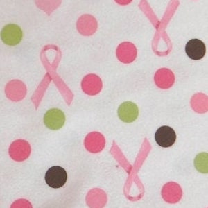 May include: White fabric with a pink, green, and brown polka dot pattern. Pink ribbon symbols are scattered throughout the fabric.