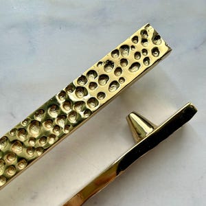 La longue barre d'or tire la texture fondue de galet, poignée de meuble en aluminium faite main de fonte en métal