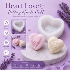 May include: A white silicone mould shaped like a heart with an embossed holding hands design. The set includes a large mould and two finished heart-shaped pieces in light pink and cream, featuring detailed hands intertwined on the surface.