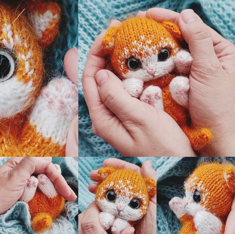 May include: A small, orange and white knitted cat toy with large black eyes. The cat is being held in the palms of two hands.