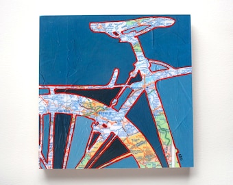 May include: A blue and white abstract painting of a bicycle made from a map of the United States. The painting features the words "Knoxville" and "Oak Ridge" on the map.