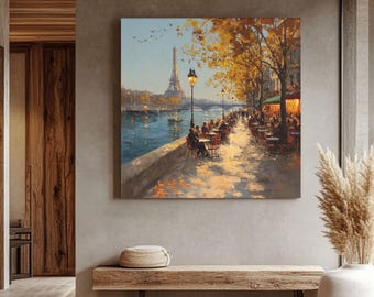 Puede incluir: Una pintura al óleo de una escena callejera parisina con la Torre Eiffel al fondo. La obra de arte muestra un café junto al río con clientes, árboles con hojas doradas y un cielo azul. La pintura se exhibe en una pared sobre un banco de madera.