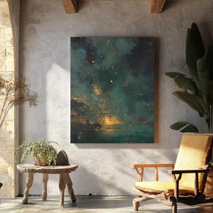 May include: An abstract canvas print with a teal and gold color palette hangs on a textured white wall. The artwork depicts a celestial scene with glowing orbs and a dark, cloudy background. A wooden chair and side table are in the foreground.