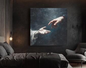 May include: A large square canvas print depicting two hands reaching towards each other, set against a dark, textured background. The artwork is displayed in a modern bedroom with dark gray bedding and walls, and a gray armchair.
