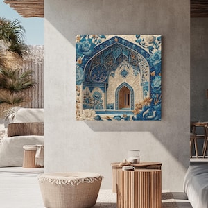 May include: A square canvas print featuring an ornate architectural design in shades of blue, beige, and gold. The artwork depicts a detailed archway with floral motifs, creating a textured, artistic aesthetic. The print is displayed on a neutral-toned wall, enhancing its visual appeal.