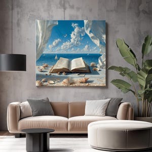 May include: A framed artwork depicts an open book with a seascape view. The ocean scene features a blue sky with fluffy white clouds, sailboats, and seashells. The artwork is displayed above a tan sofa and a round ottoman.