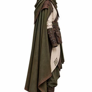 May include: A hooded olive green cloak worn over a beige tunic and dark green trousers. The outfit includes brown leather bracers with buckles, a brown leather belt with an attached pouch, and brown lace-up boots. A diamond-shaped emblem is visible.
