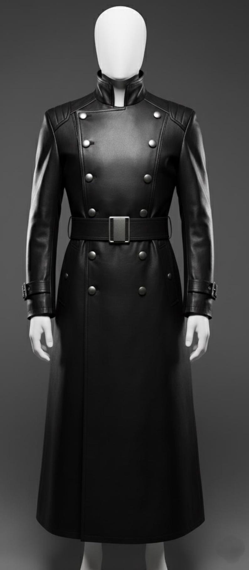 May include: A long, black leather coat with a double-breasted design. The coat features a belted waist, silver-coloured buttons, and a high collar. The sleeves have buttoned cuffs. The coat is displayed on a mannequin.