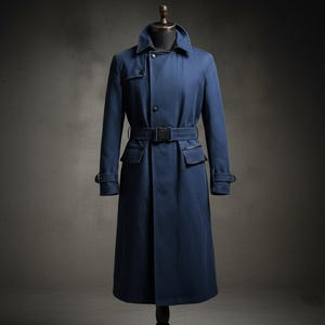 May include: A navy blue trench coat with a belted waist and a classic collar. The coat features a double-breasted design with button closures, two front pockets, and adjustable cuffs. The coat is displayed on a mannequin.