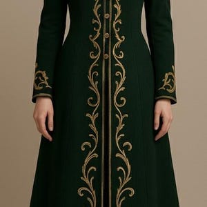 May include: A long, dark green coat with gold embroidered detailing. The coat features a high collar, button closures, and ornate gold scrollwork down the front and on the sleeves. A classic, elegant design.