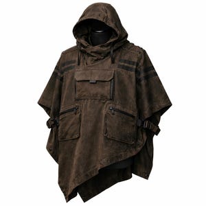 May include: Brown hooded poncho with black accents. Features include a front pocket with a zipper, two side pockets with zippers, and black stripes across the shoulders. The poncho has a unique asymmetrical cut and adjustable buckles.