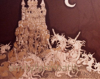May include: A brown and cream batik textile art piece featuring a stone castle on a cliffside, a crescent moon, and a group of unicorns. The text amityfarmbatik is printed in the lower section of the artwork, which displays intricate line work.