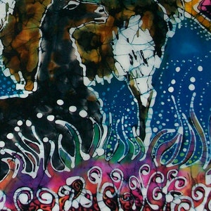 May include: A batik painting featuring a black and white llama with a blue and white background. The llama is surrounded by colorful flowers and plants.
