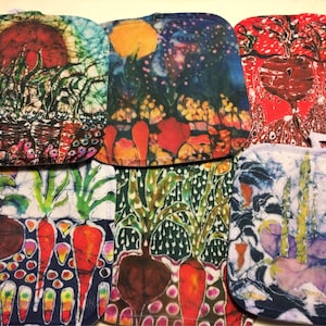 May include: Set of six colorful fabric pot holders with a vegetable garden theme. The pot holders feature a variety of vegetables, including carrots, beets, and other leafy greens. The designs are vibrant and intricate, with a batik style.