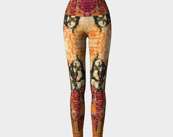 May include: High-waisted yoga leggings with a colourful abstract print featuring orange, red, and black. The print has a symmetrical design with a floral pattern.
