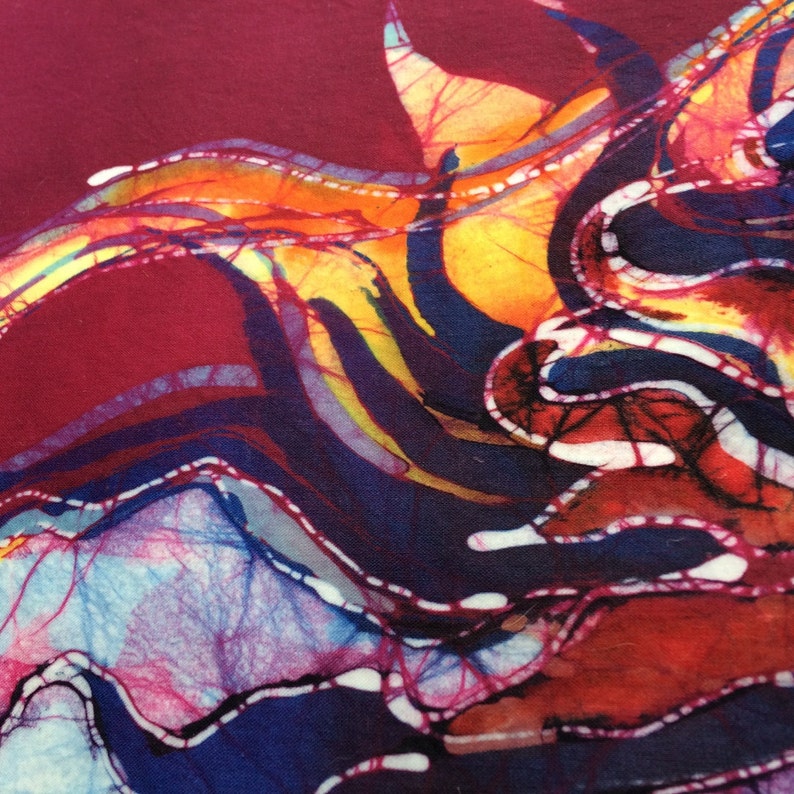 May include: Abstract batik fabric with a swirling pattern of red, orange, yellow, blue, and white.