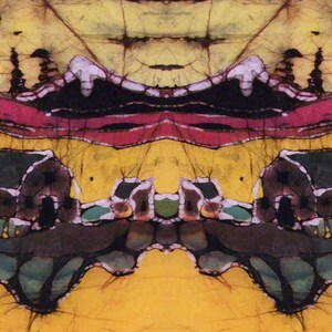 May include: Abstract batik art with a symmetrical design. The artwork features a vibrant colour palette of yellow, red, black, and green. The composition includes stylised landscape elements, possibly depicting buildings and natural forms.