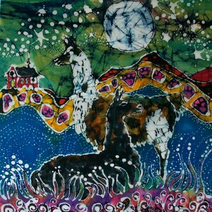 May include: A batik painting of two llamas standing in a field of flowers under a full moon and a starry sky. The llamas are white and black with brown accents. The background is a vibrant blue with green and yellow accents.