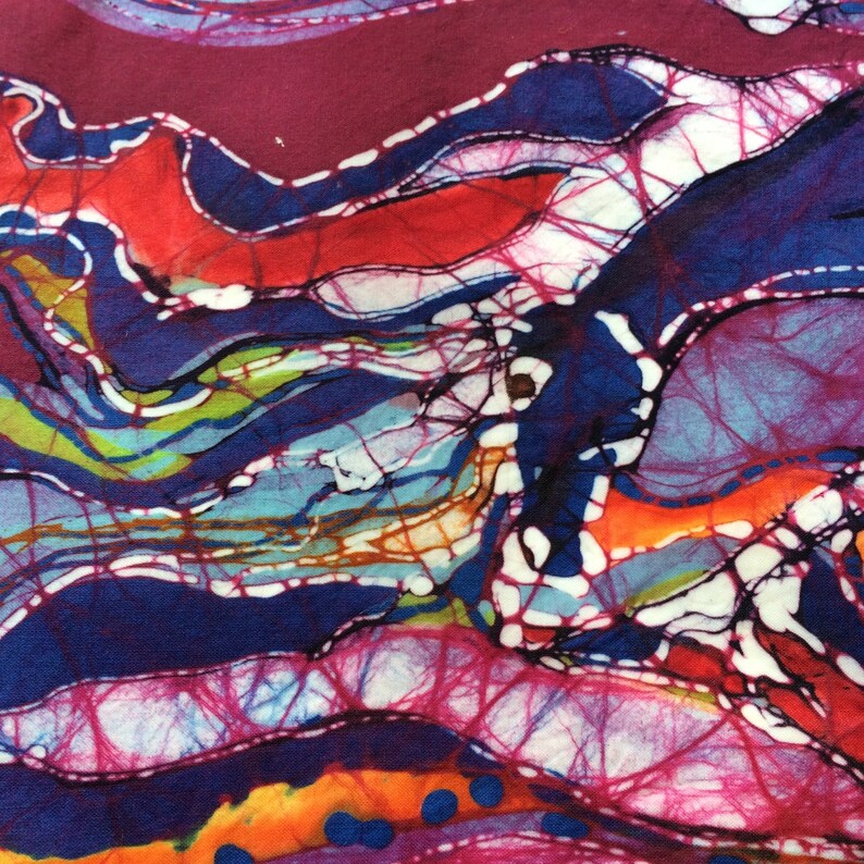 May include: Abstract batik fabric with a colorful design of swirling lines and shapes in shades of blue, red, pink, orange, yellow, green, and white.