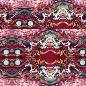 May include: Abstract batik pattern in shades of red, blue, yellow, and white. The pattern is symmetrical and features a series of curved lines and circles.