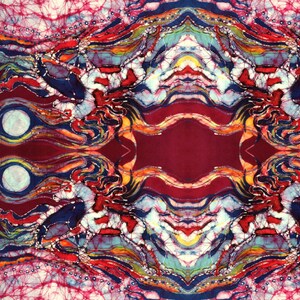 May include: Abstract batik fabric with a symmetrical design featuring swirling patterns in shades of red, blue, yellow, and white.