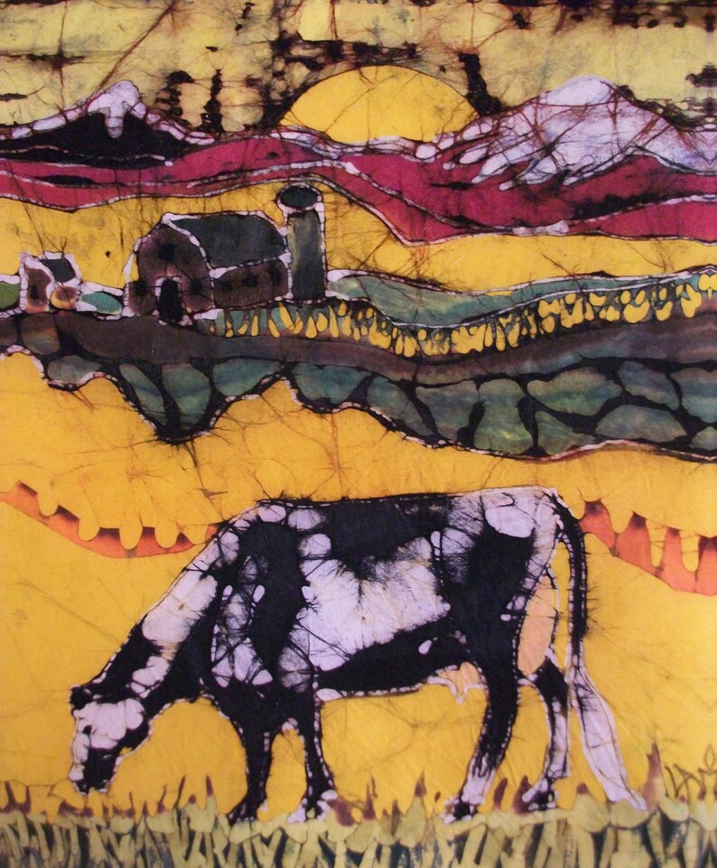 May include: A batik painting of a rural scene, showing a black and white cow grazing. The artwork includes a barn, rolling hills, and a sunset in yellow, red, and green hues, creating a vibrant countryside image.
