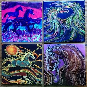 May include: Four square art tiles featuring horse-themed designs. One tile shows two blue horses on a pink and blue background. Another depicts flowing, colorful manes against a blue backdrop. The other two tiles show a horse with a sun and a horse's head.