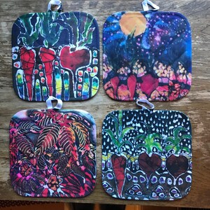 May include: Four colorful square pot holders with a tie-dye design featuring a variety of patterns and colors, including red, blue, green, black, and white. The pot holders are made of fabric and have a loop for hanging.