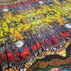 May include: A colorful batik fabric with a design of a forest with trees and a moon. The fabric has a dark purple background with red, yellow, and green accents.