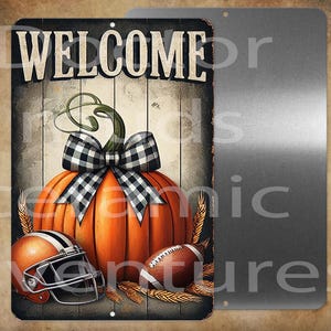 May include: A metal sign with a rustic design featuring a large orange pumpkin with a black and white checkered bow. The sign also includes a football, a football helmet, and the word "WELCOME" in bold letters.