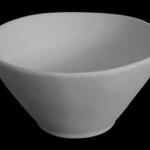 May include: A light gray, ceramic bowl with a wide, slightly irregular rim. The bowl has a conical shape, widening from a rounded base to the opening. The bowl is set against a black background.