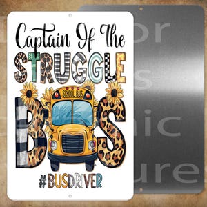 May include: A rectangular metal sign with the words "Captain of the Struggle Bus" in black script. The word "STRUGGLE" is in various patterns, and a yellow school bus is in the center. The sign also includes the hashtag #BUSDRIVER.