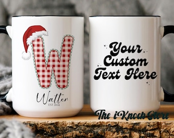 May include: White ceramic mug with a black handle and rim. One mug features a red and white gingham "W" with a Santa hat and the name "Watter". The other mug has the text "Your Custom Text Here". The iKnock Store logo is at the bottom.